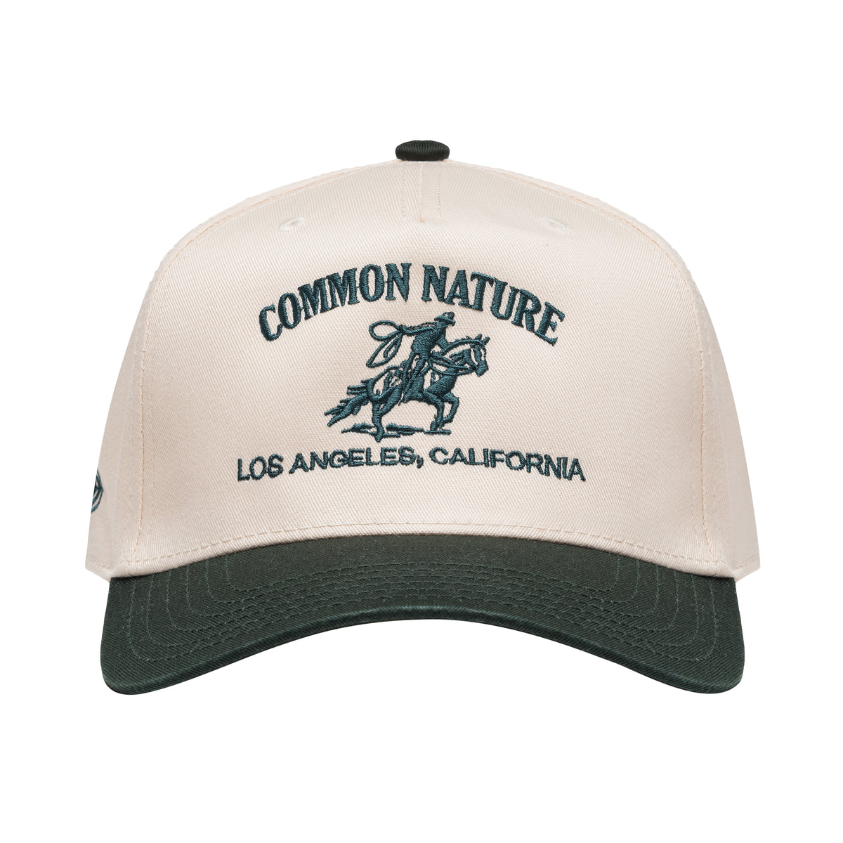 Rider's Hat in natural and black, front view with embroidered rider and Common Nature logo