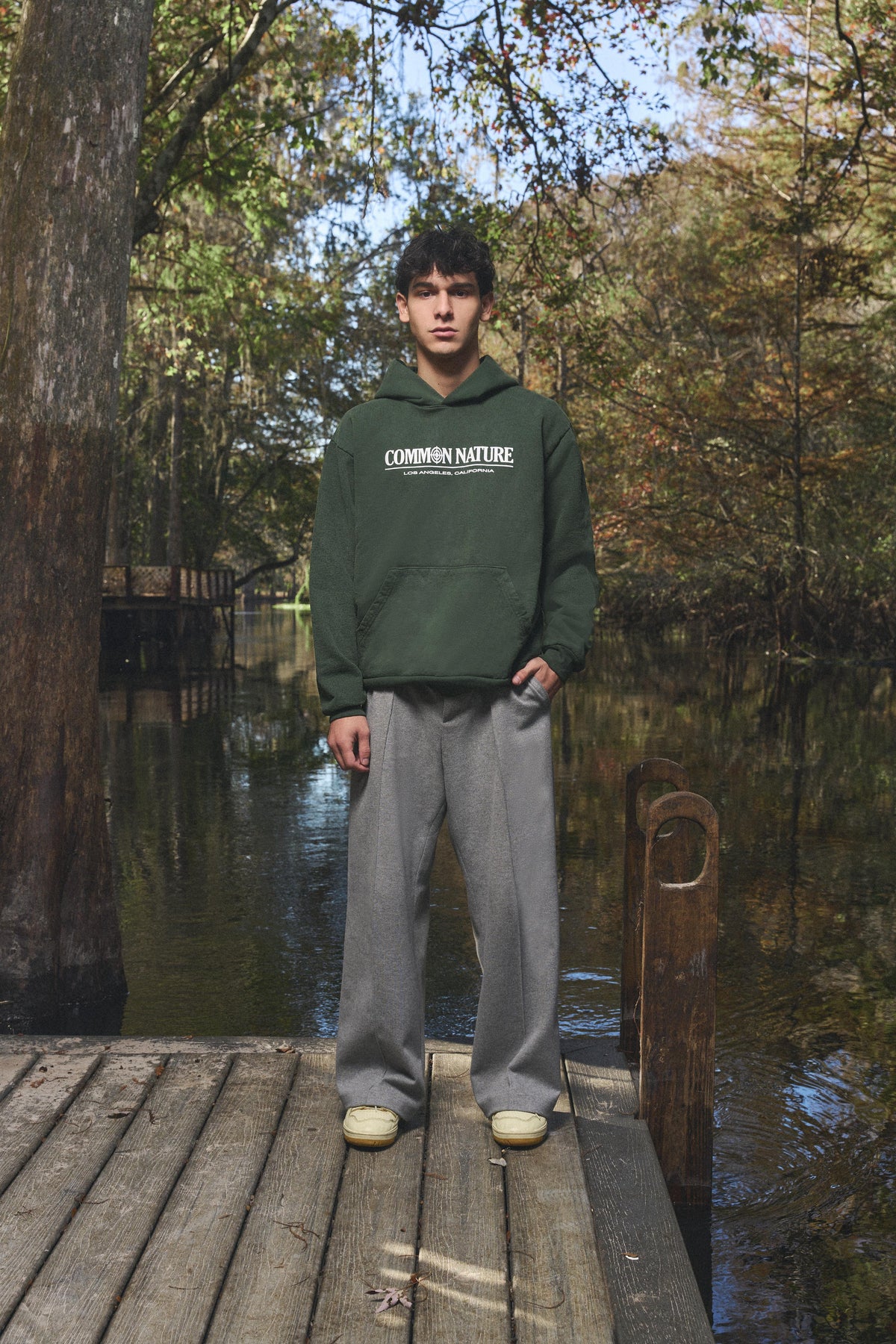 Man wearing the Western Frontier Hoodie in forest green, front view