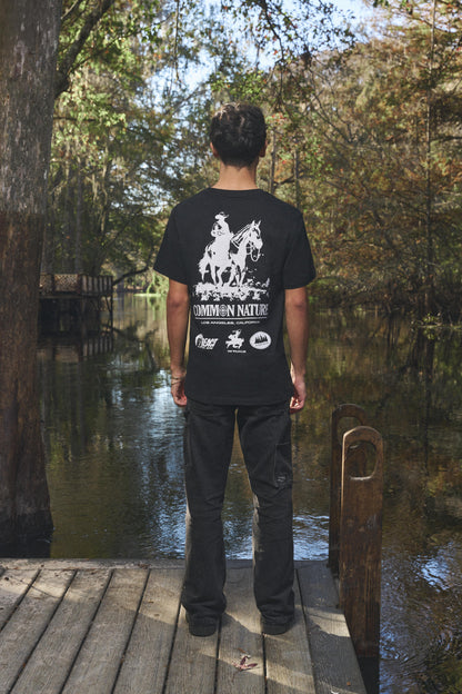 Man wearing the Western Frontier Tee in black, back view