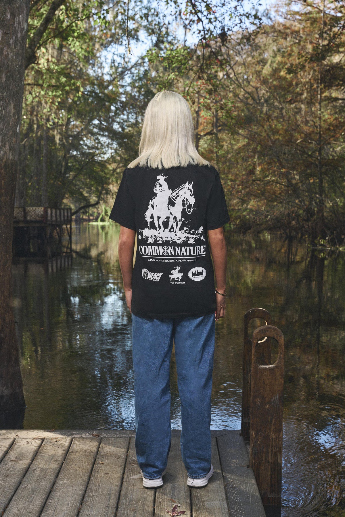 Woman wearing the Western Frontier Tee in black, back view