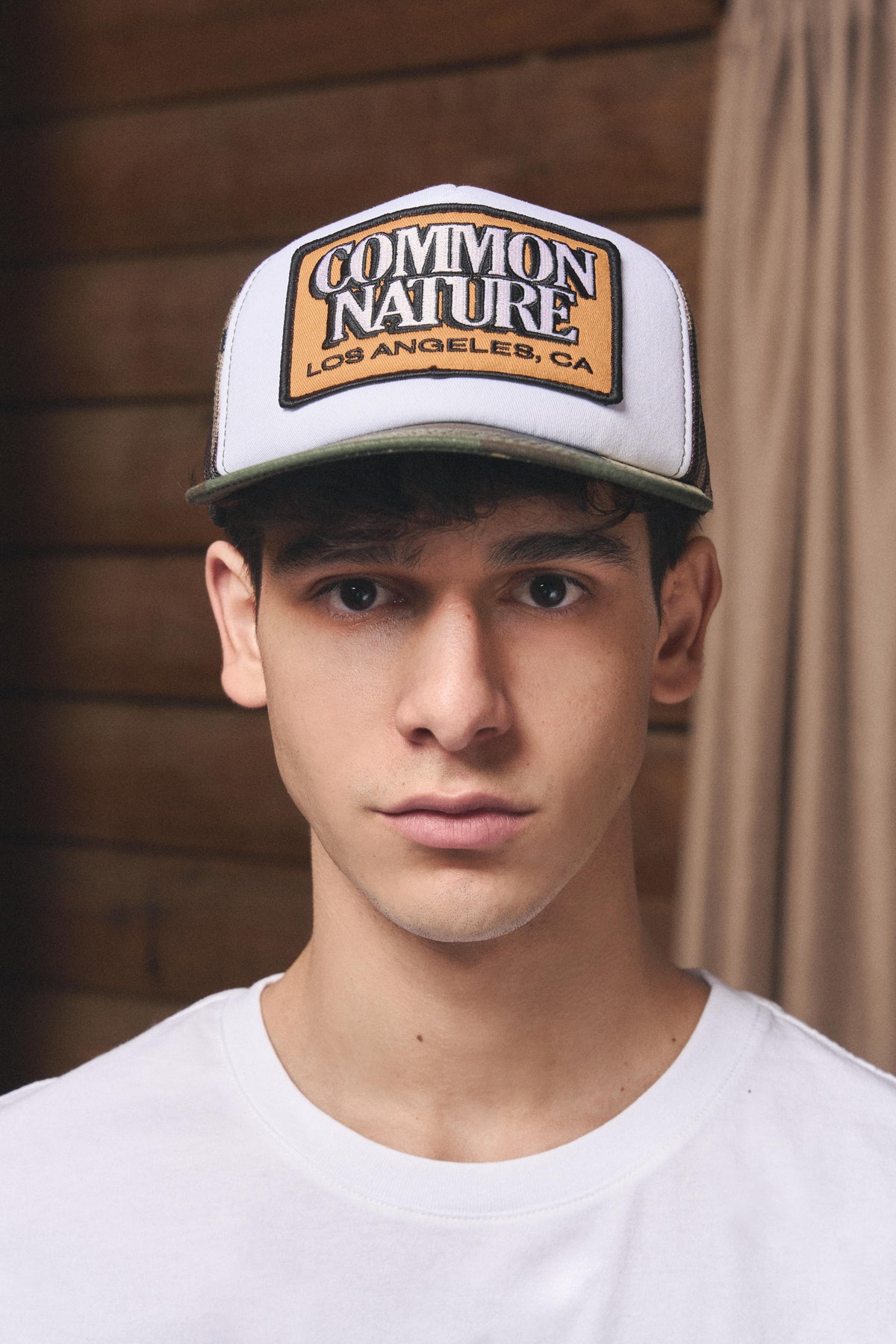 Man wearing the Common Patch Hat in camo