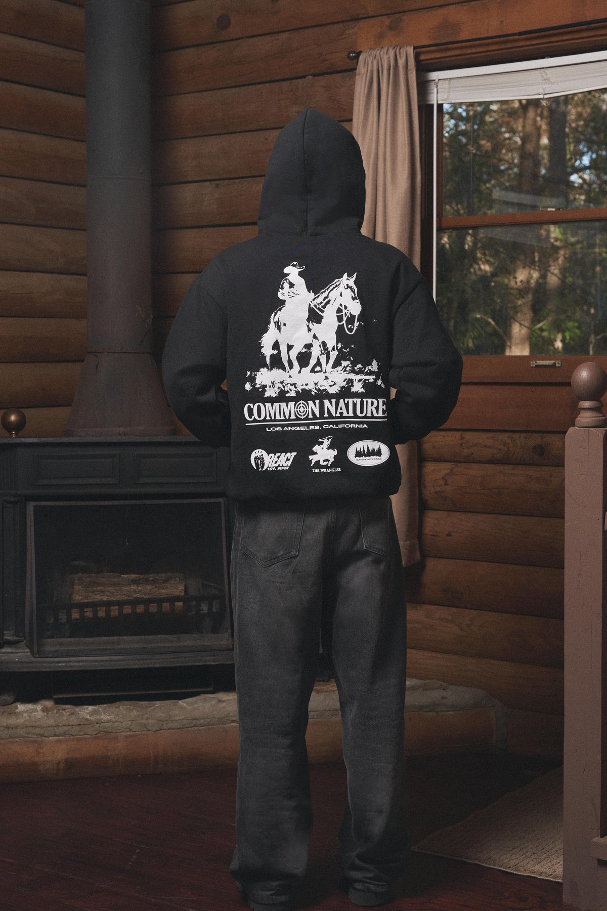 Man wearing the Western Frontier Hoodie in black, back view