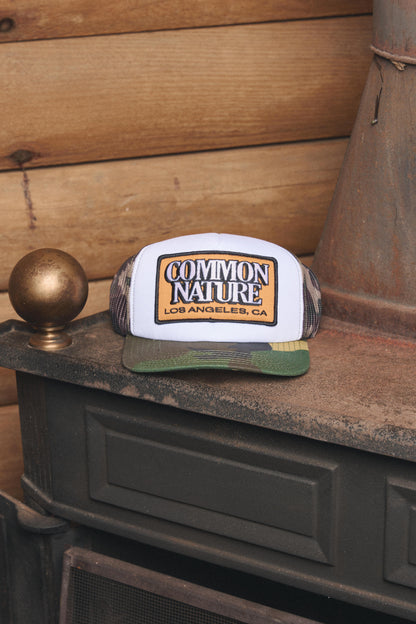 Common Patch Hat in camo styled on a vintage stove