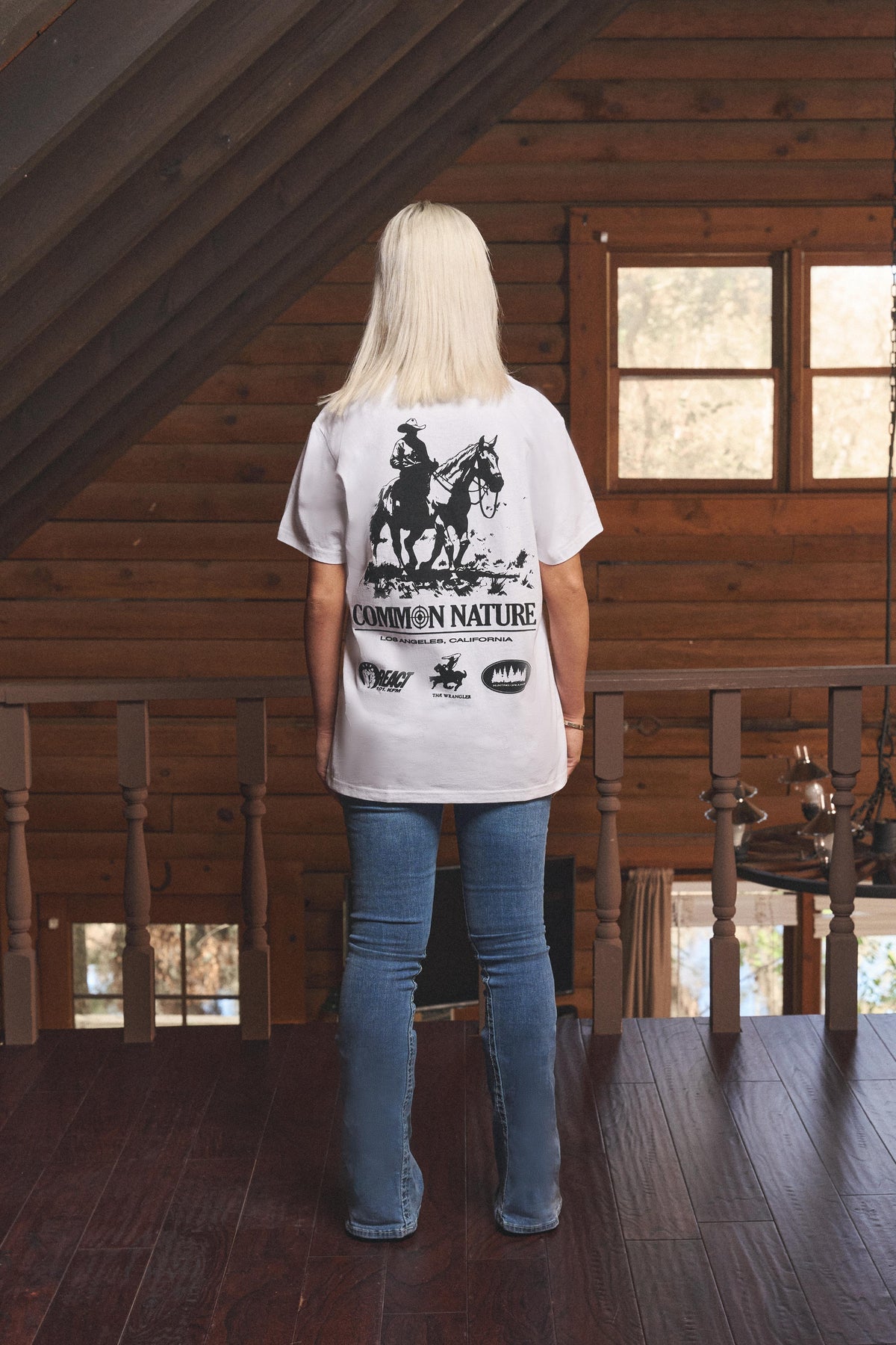 Woman wearing the Western Frontier Tee in white, back view
