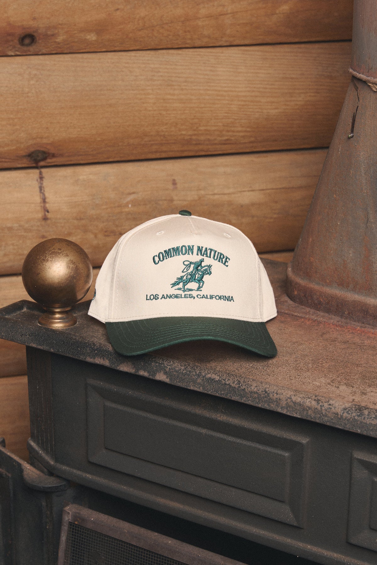Rider's Hat in natural and black resting on a vintage stove