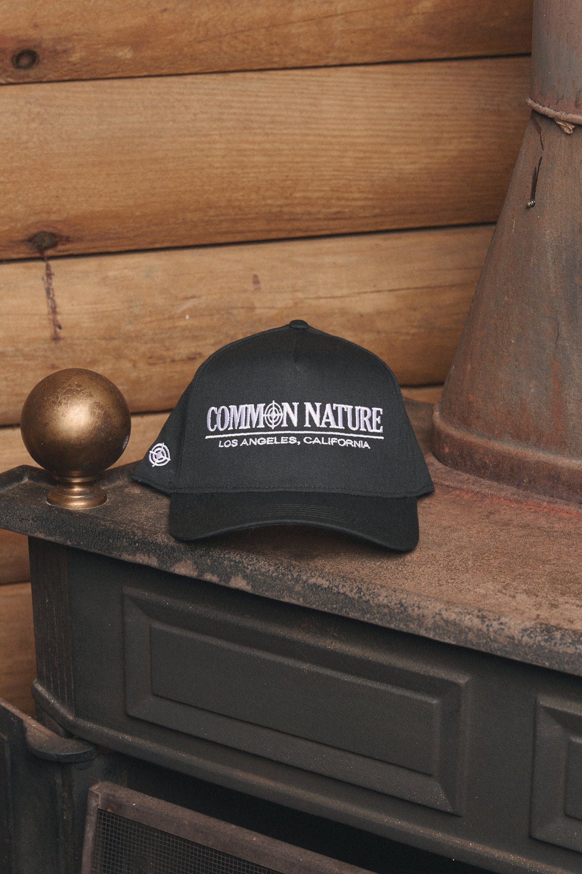Classic Target Hat in black resting on a vintage stove