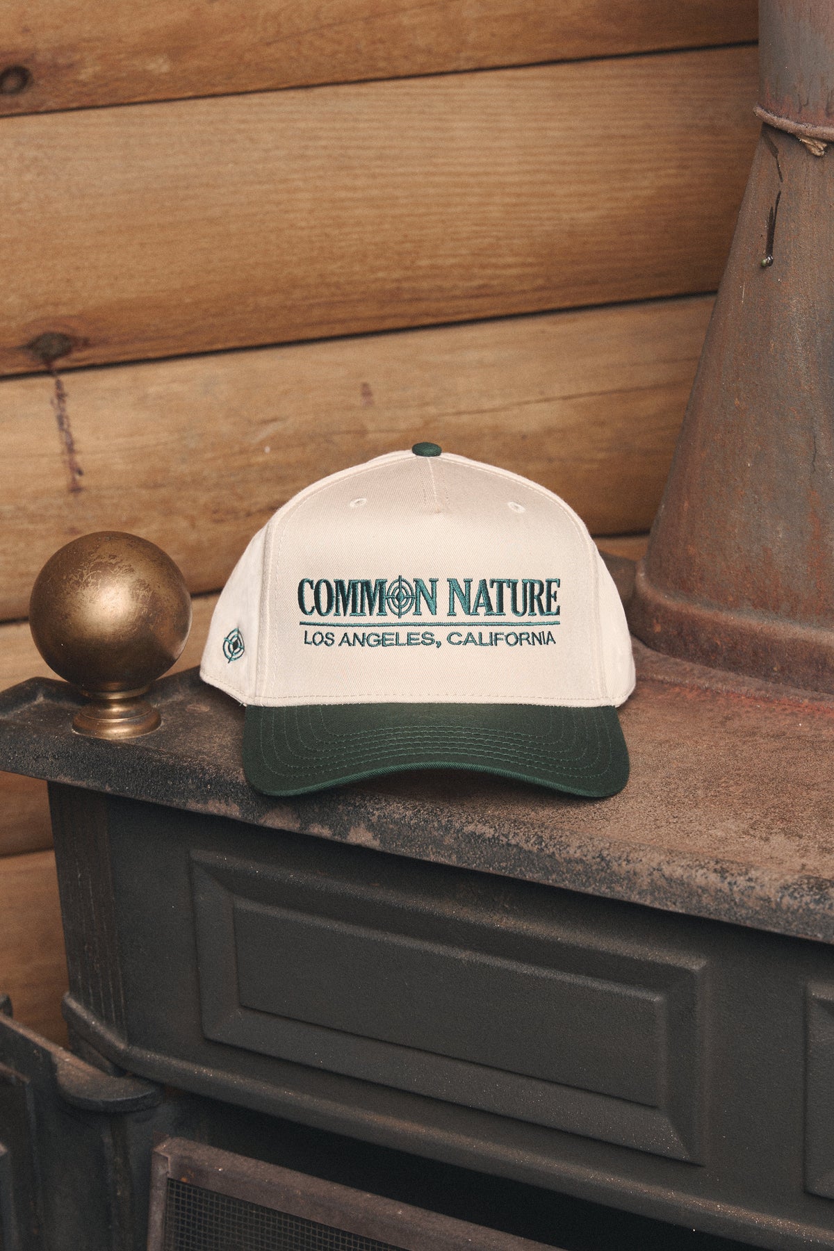 Classic Target Hat in natural and black resting on a vintage stove